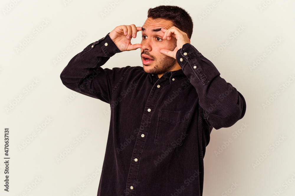 Young caucasian man isolated on white background keeping eyes opened to find a success opportunity. Young caucasian man isolated on white background keeping eyes opened to find a success opportunity.