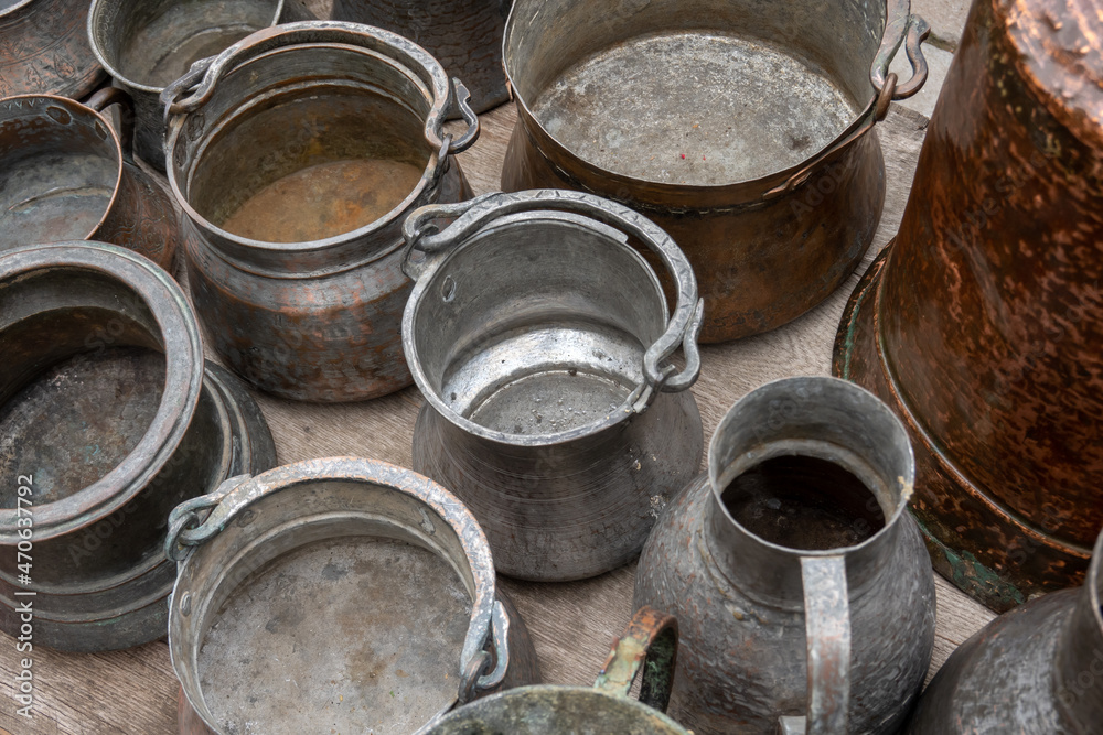 Assorted copperware and rugs on flea market Assorted copperware and rugs on flea market