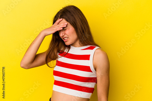 Young caucasian woman isolated on yellow background touching temples and having headache.