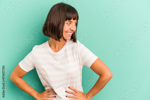 Young mixed race woman isolated on blue Young mixed race woman isolated on blue background feeling energetic and comfortable, rubbing hands confident. © Asier