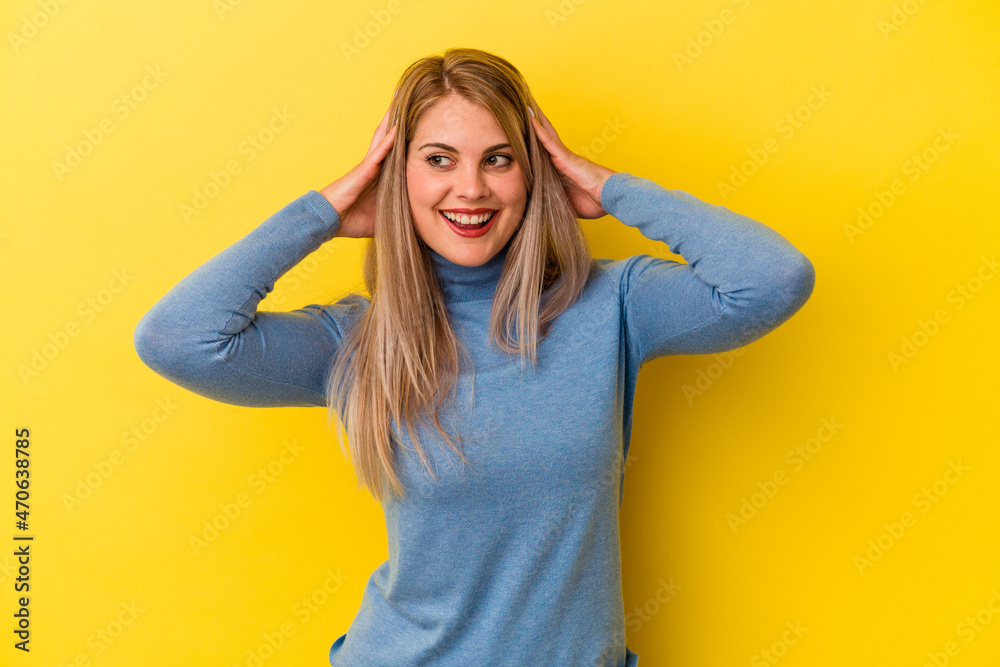 Young russian woman isolated on yellow background screaming, very excited, passionate, satisfied with something. Young russian woman isolated on yellow background screaming, very excited, passionate, satisfied with something.