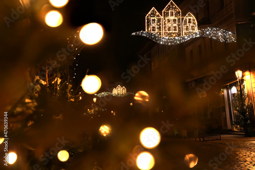 Defocused magical Christmas background. New Year lights on street of night festive city
