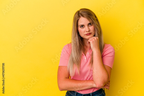 Young russian woman isolated on yellow background who feels sad and pensive, looking at copy space.