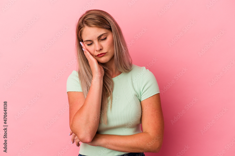 Young russian woman isolated on pink background who is bored, fatigued and need a relax day. Young russian woman isolated on pink background who is bored, fatigued and need a relax day.