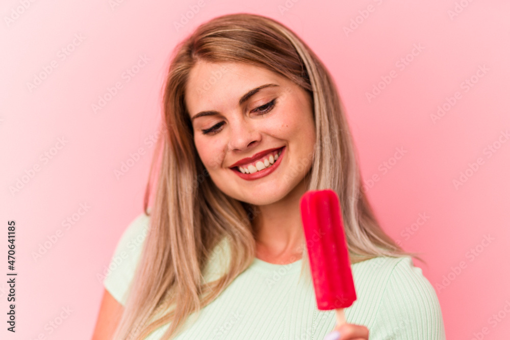 Young russian woman holding an ice cream isolated on pink background Young russian woman holding an ice cream isolated on pink background