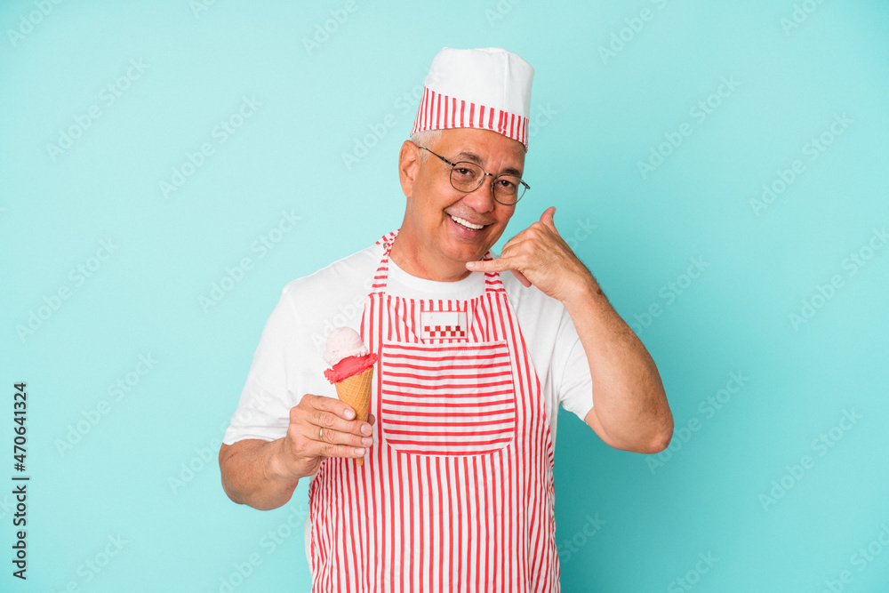 Senior american ice cream maker holding an ice cream isolated on blue background showing a mobile phone call gesture with fingers. Senior american ice cream maker holding an ice cream isolated on blue background showing a mobile phone call gesture with fingers.