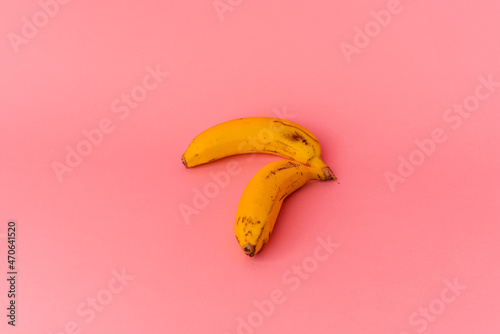 Two bananas isolated on pink background