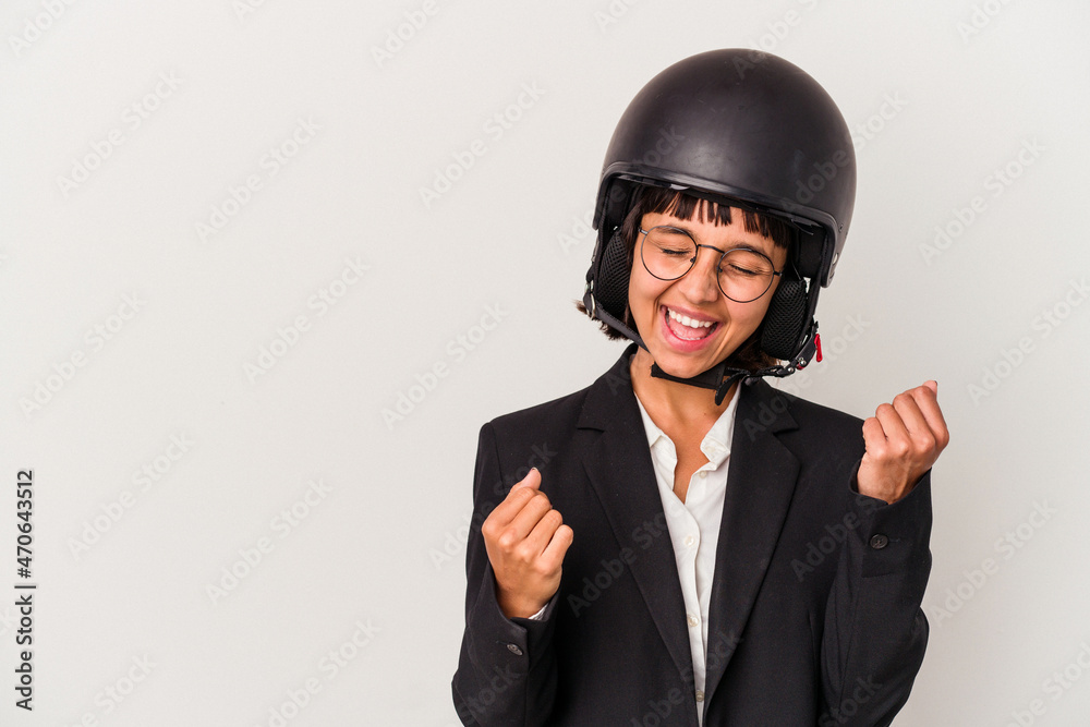 Young mixed race business woman wearing a motorbike helmet isolated raising fist after a victory, winner concept. Young mixed race business woman wearing a motorbike helmet isolated raising fist after a victory, winner concept.