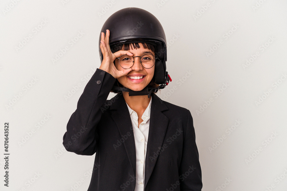 Young mixed race business woman wearing a motorbike helmet isolated excited keeping ok gesture on eye. Young mixed race business woman wearing a motorbike helmet isolated excited keeping ok gesture on eye.