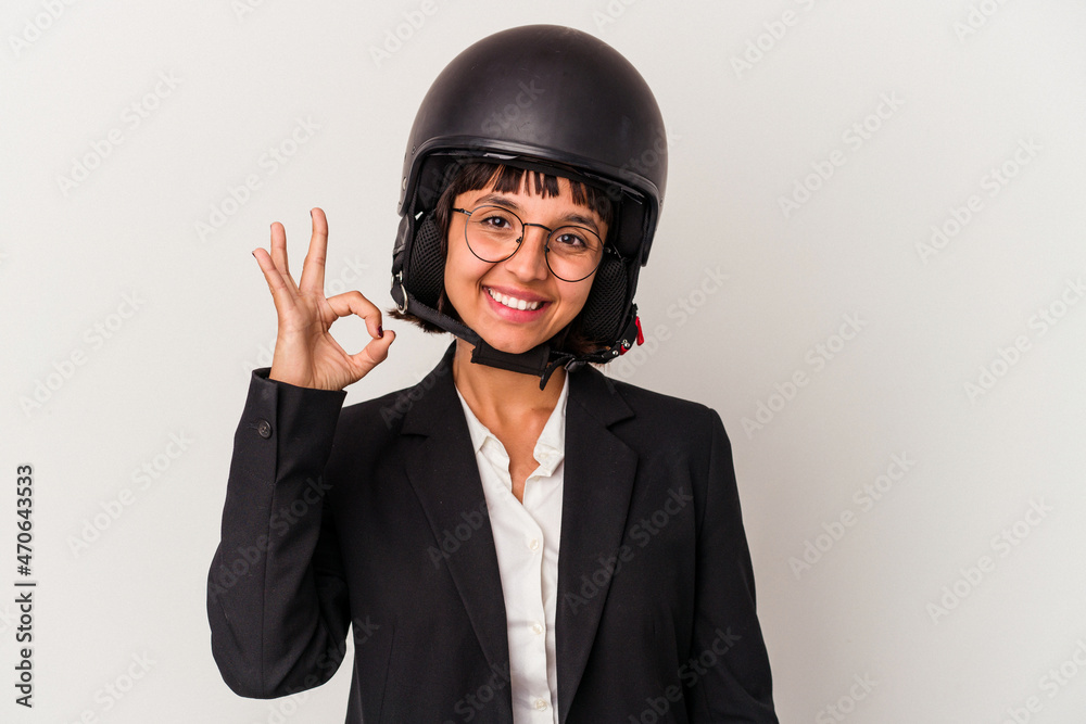 Young mixed race business woman wearing a motorbike helmet isolated cheerful and confident showing ok gesture. Young mixed race business woman wearing a motorbike helmet isolated cheerful and confident showing ok gesture.
