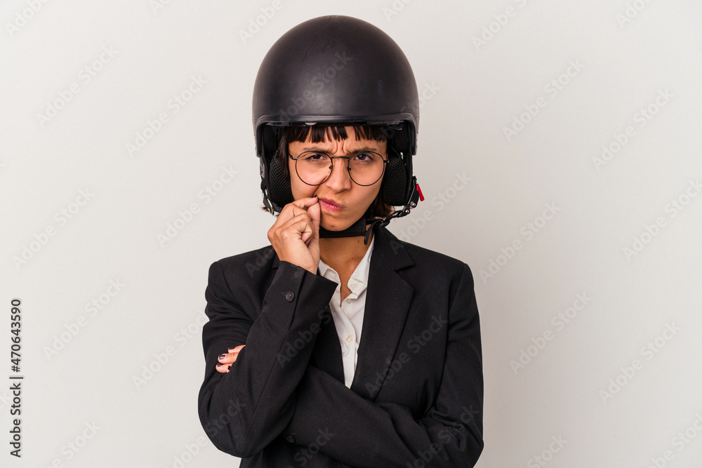 Young mixed race business woman wearing a motorbike helmet isolated with fingers on lips keeping a secret. Young mixed race business woman wearing a motorbike helmet isolated with fingers on lips keeping a secret.