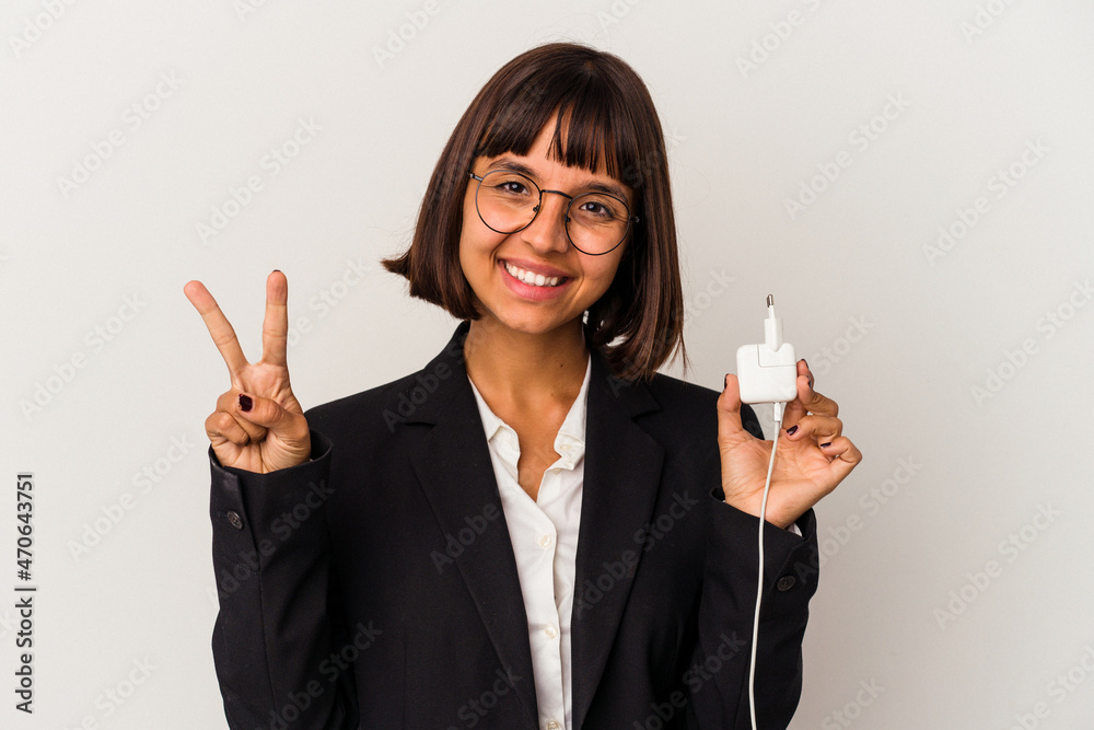 Young mixed race business woman holding a phone charger isolated on white background pointing with finger at you as if inviting come closer. Young mixed race business woman holding a phone charger isolated on white background pointing with finger at you as if inviting come closer.