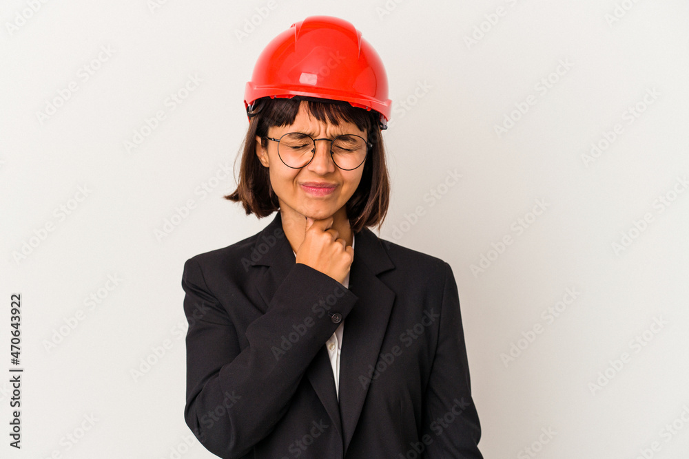 Young architect woman with red helmet isolated on white background suffers pain in throat due a virus or infection. Young architect woman with red helmet isolated on white background suffers pain in throat due a virus or infection.