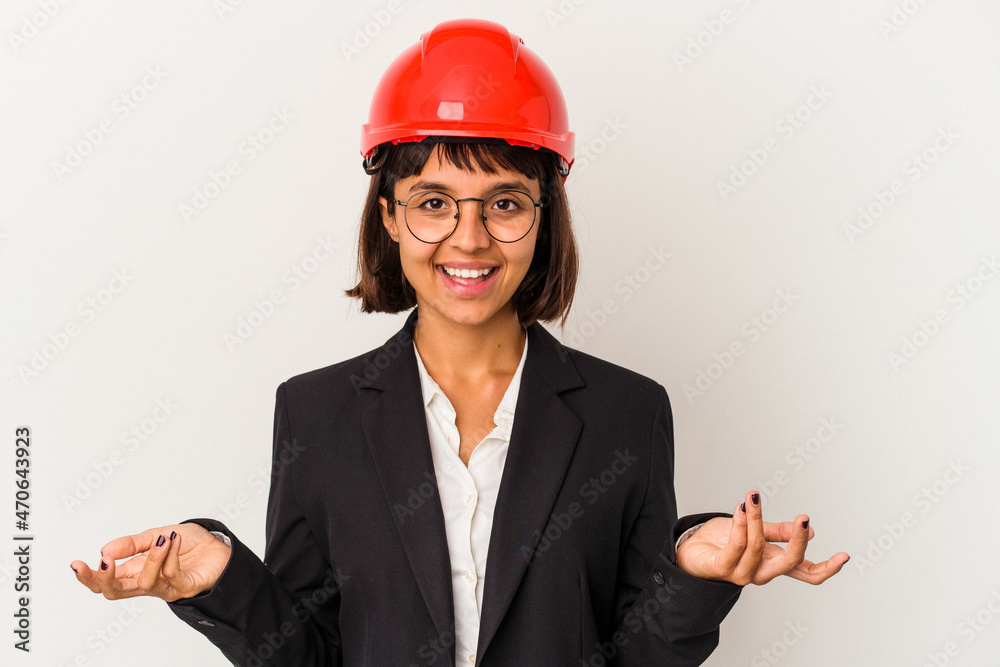 Young architect woman with red helmet isolated on white background showing a welcome expression. Young architect woman with red helmet isolated on white background showing a welcome expression.