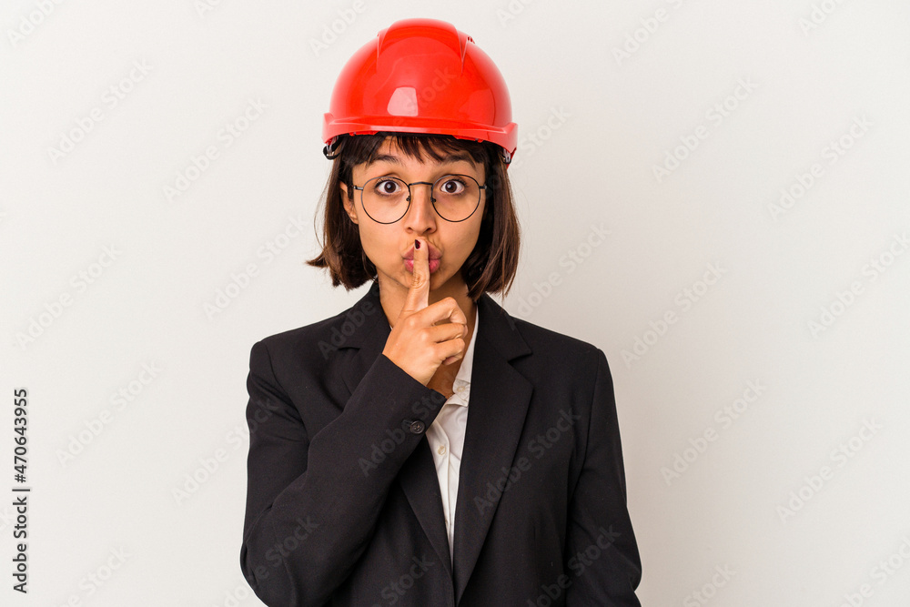 Young architect woman with red helmet isolated on white background keeping a secret or asking for silence. Young architect woman with red helmet isolated on white background keeping a secret or asking for silence.