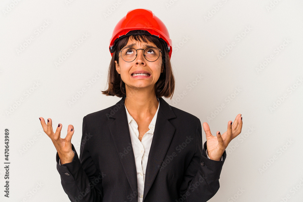 Young architect woman with red helmet isolated on white background screaming to the sky, looking up, frustrated. Young architect woman with red helmet isolated on white background screaming to the sky, looking up, frustrated.