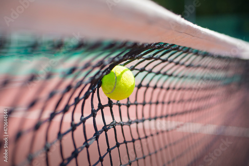 Tennis ball hits in the net during game.