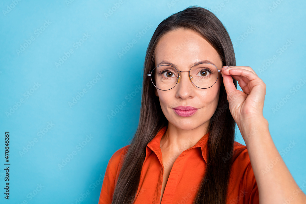 Photo of thoughtful confident young woman wear red shirt arm spectacles empty space isolated blue color background Photo of thoughtful confident young woman wear red shirt arm spectacles empty space isolated blue color background