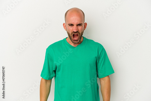Young bald man isolated on white background shouting very angry, rage concept, frustrated.