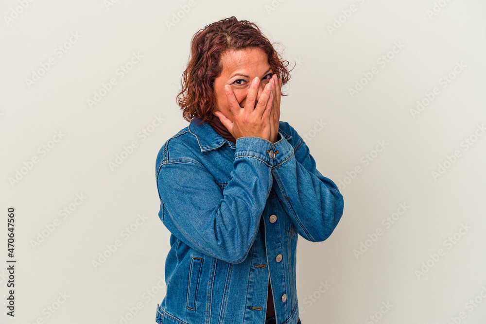 Middle age latin woman isolated on white background blink through fingers frightened and nervous. Middle age latin woman isolated on white background blink through fingers frightened and nervous.