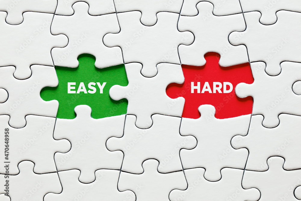 Missing puzzle pieces with the words easy versus hard. To make a choice between the options of easy or hard way. Missing puzzle pieces with the words easy versus hard. To make a choice between the options of easy or hard way.