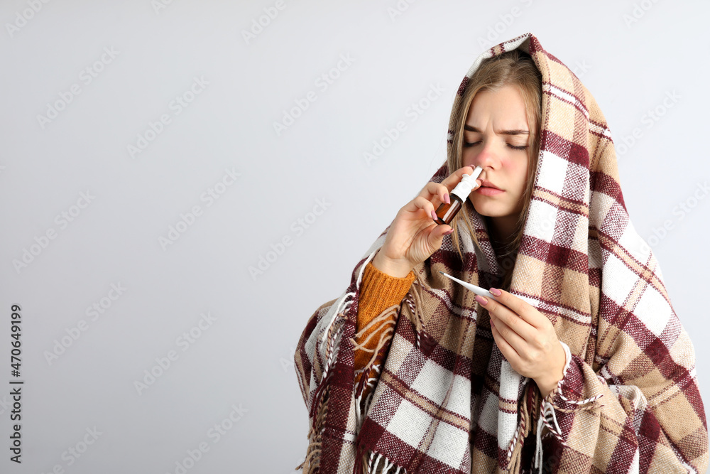 Ill young woman on light background, seasonal cold concept Ill young woman on light background, seasonal cold concept