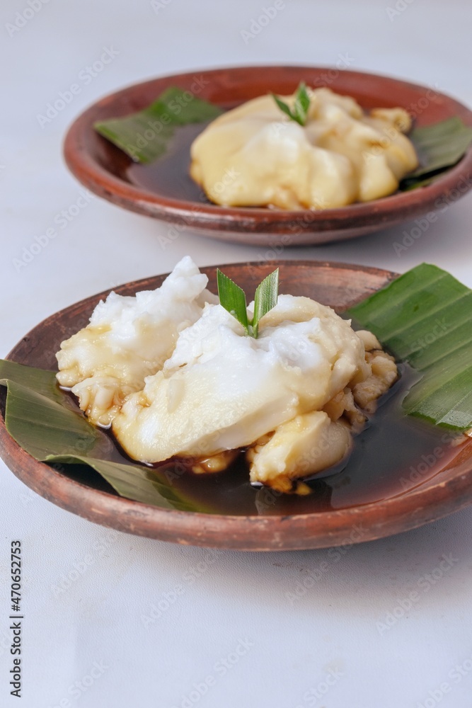 bubur sumsum,Indonesian traditional dessert or boiled rice flour in coconut milk served with palm sugar syrup	