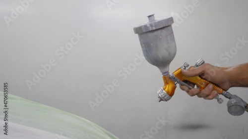 Close-up of a air spray gun using compressed air to paint a car. photo