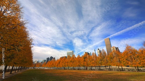 Rows of autumnal leaf color trees stand under the autumnal clouds in Franklin D. Roosevelt Four Freedoms Park at Roosevelt Island on the East River on November 14, 2021 in New City.  photo