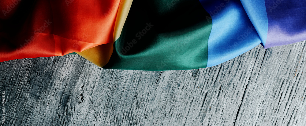rainbow flag on a gray surface, web banner