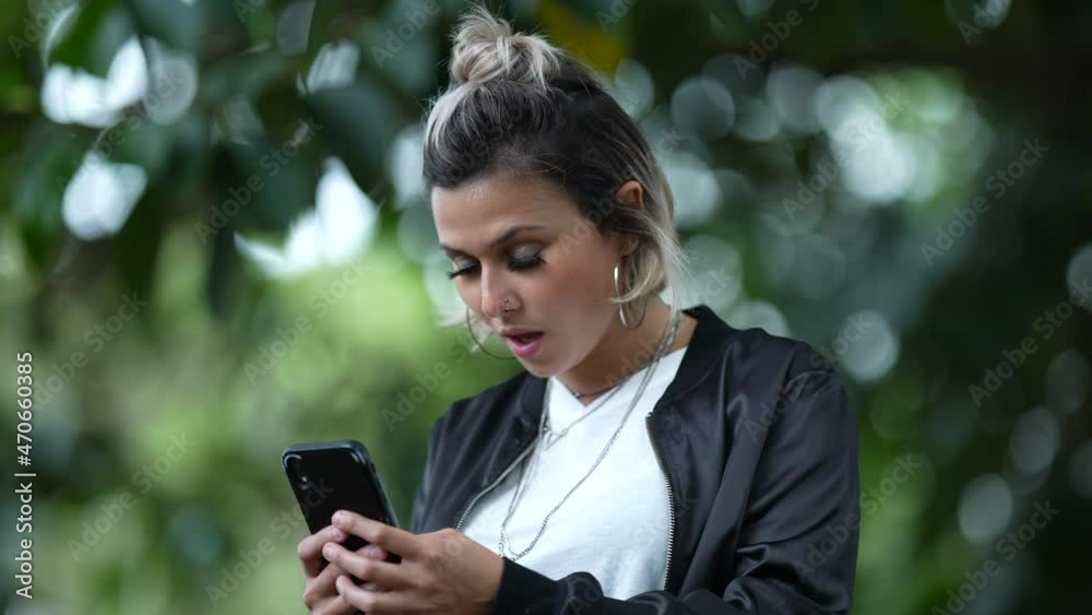Woman reading shocking message on cellphone message. Surprised emotion to news Woman reading shocking message on cellphone message. Surprised emotion to news