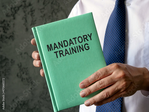 Employee holds mandatory training guide in the hands. photo