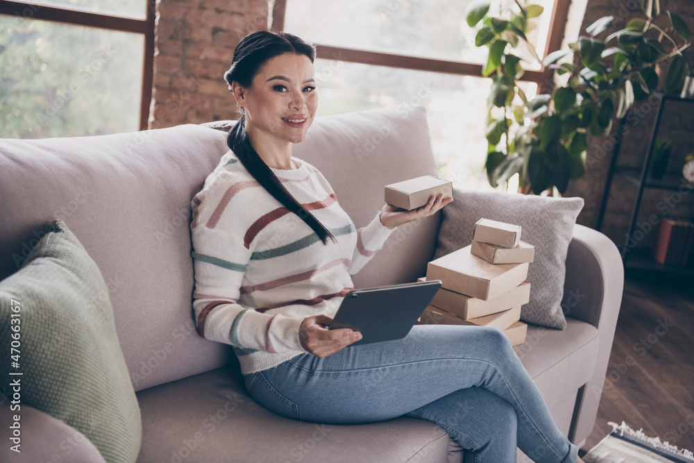 Profile side photo of young cheerful woman entrepreneur quarantine use modern device tablet consumerism indoors Profile side photo of young cheerful woman entrepreneur quarantine use modern device tablet consumerism indoors