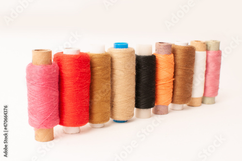 Threads of Warm shades on a white background.