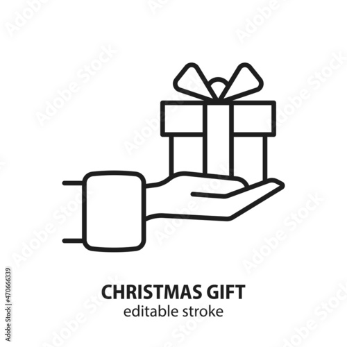 Hand with Christmas gift box line vector icon. Editable stroke.