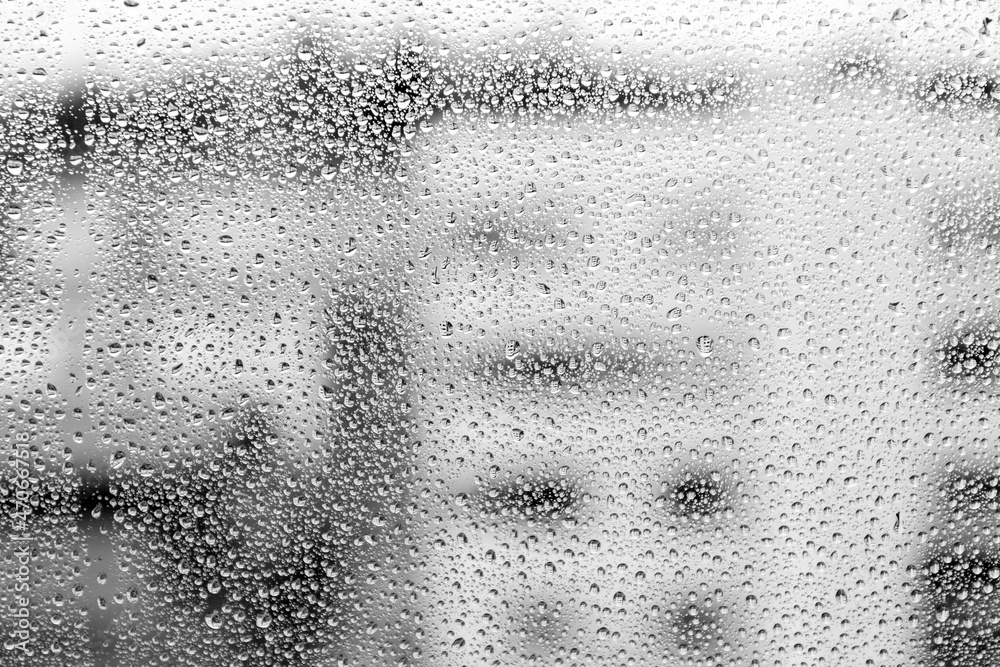 Raindrops on glass on a blurred background. Rain on the window. Texture. Photo