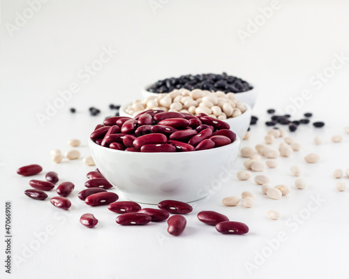 Assortment of beans in a white bowl on white background