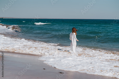 Woman in white dress near the ocean walk fresh air landscape