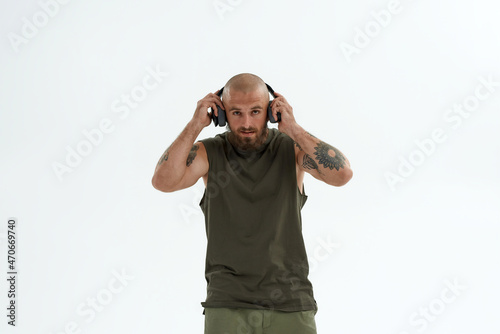Caucasian man correcting earphones on his ears