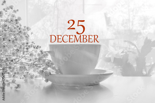 calendar date on light background with porcelain white tea pair and white gypsophila with copy space. December 25 is the twenty-fifth day of the month