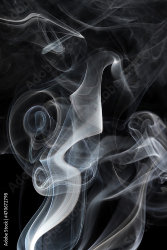 abstract white smoke swirls on black background 