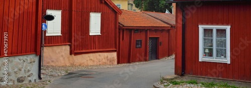 Traditional swedish houses colored with falu red dye. Tiled roofs. Empty street. Strängnäs, Mälaren lake, Sweden. Travel destinations, landmarks, sightseeing, vacations, recreation, estate, home photo