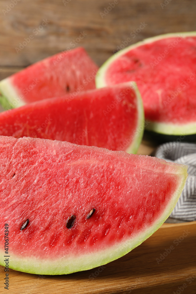 Delicious fresh watermelon slices on wooden board, closeup