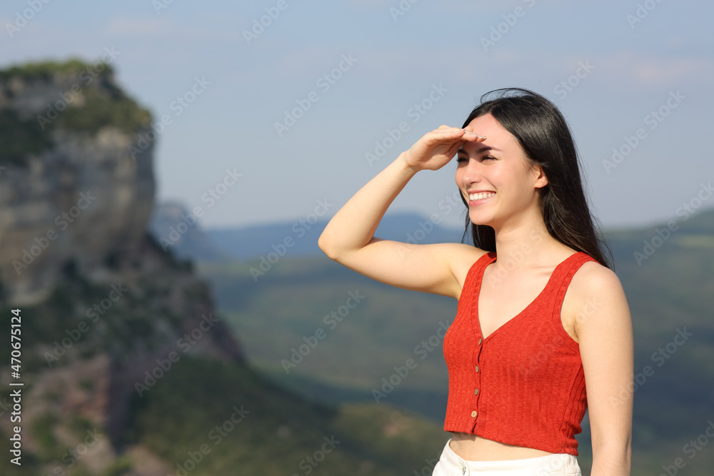 Happy asian woman seaching protecting from sun outdoors Happy asian woman seaching protecting from sun outdoors