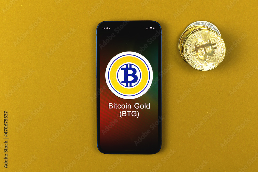 Bitcoin Gold BTG symbol. Trade with cryptocurrency, digital and virtual money, banking with mobile phone concept. Business workspace, table top view photo