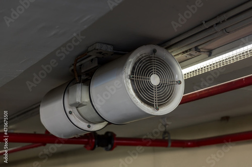 Fan in modern building Parking in door. Parking building ventilation system. blower flow air for confined space work in factory. Industrial Fan Heater and Cooler.