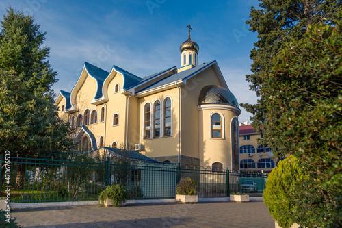 view of a beautiful church with a blue roof, an Orthodox church