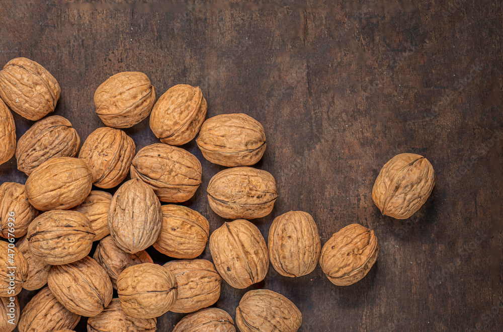 Walnut. Peeled walnut kernel nut on wooden background. Top view. Flat lay. Walnut. Peeled walnut kernel nut on wooden background. Top view. Flat lay.