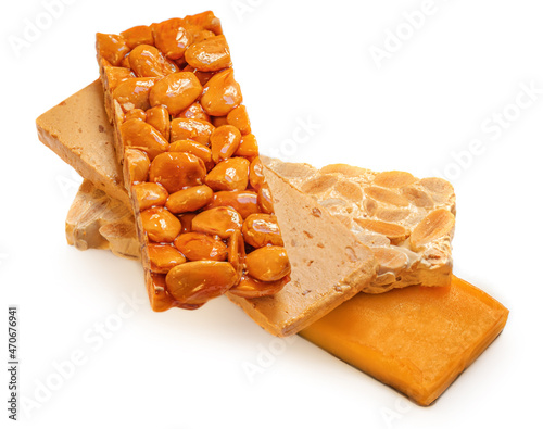 Turron nougat - traditional almond and caramel dessert isolated on white background. Christmas Turron candy. photo