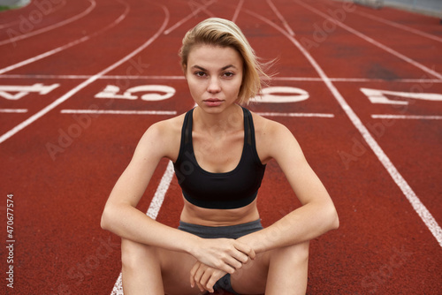 Blonde confident sports woman on stadium treadmill